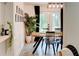 Bright dining room with modern lighting, a large wooden table, black chairs and backyard access at 944 Hardy Cir, Dallas, GA 30157
