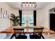 Dining room with a large wooden table, modern lighting, and French doors opening to the backyard at 944 Hardy Cir, Dallas, GA 30157