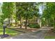 Two-story home with a long driveway and lush landscaping, set amongst mature trees at 944 Hardy Cir, Dallas, GA 30157
