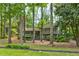 View of the two-story home with a welcoming front porch surrounded by mature trees at 944 Hardy Cir, Dallas, GA 30157