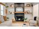 A cozy fireplace featuring a dark facade, wooden mantle, decorative shelves, and ambient lighting at 944 Hardy Cir, Dallas, GA 30157