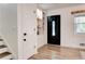 Welcoming foyer with hardwood floors, built-in shelving, and a stylish front door at 944 Hardy Cir, Dallas, GA 30157