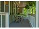 Cozy front porch featuring seating and hanging plants for an inviting outdoor space at 944 Hardy Cir, Dallas, GA 30157