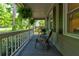 Relaxing front porch with comfortable seating and a view of the surrounding greenery at 944 Hardy Cir, Dallas, GA 30157