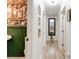 Inviting hallway featuring hardwood floors, gallery wall and a stylish mirror, leading to other rooms at 944 Hardy Cir, Dallas, GA 30157