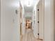 Bright hallway featuring light wood-look floors and access to the basement staircase at 944 Hardy Cir, Dallas, GA 30157
