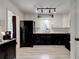 Modern kitchen with black and white cabinetry, stainless steel appliances, and recessed lighting at 944 Hardy Cir, Dallas, GA 30157
