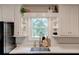 Bright kitchen featuring a stainless steel sink, white countertops, and natural light from the window at 944 Hardy Cir, Dallas, GA 30157