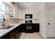 Modern kitchen featuring white countertops and upper cabinets, with dark lower cabinets and stainless steel appliances at 944 Hardy Cir, Dallas, GA 30157