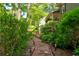 Path leading to the home, lined with lush landscaping and charming outdoor lighting at 944 Hardy Cir, Dallas, GA 30157