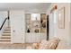 A well-lit living room featuring a stairway, a built-in shelving unit, and white walls at 944 Hardy Cir, Dallas, GA 30157