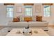 Comfortable living room with a large couch, stylish throw pillows, and multiple windows for ample natural light at 944 Hardy Cir, Dallas, GA 30157