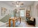 Home office with painted accent wall, natural light, ceiling fan, and small book shelf at 944 Hardy Cir, Dallas, GA 30157