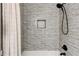 Stylish shower with textured grey subway tile and black fixtures at 944 Hardy Cir, Dallas, GA 30157