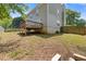 Exterior view of a house with a wooden deck, surrounded by a fenced backyard and green foliage at 109 Riley Way, Canton, GA 30115