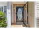 Inviting front door with decorative glass and brick accents, enhancing the entrance at 109 Riley Way, Canton, GA 30115