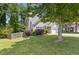 Landscaped front yard showcasing a well-maintained lawn, garden bed and two car garage at 109 Riley Way, Canton, GA 30115