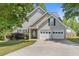 Charming home with a two-car garage and inviting front yard, offering curb appeal at 109 Riley Way, Canton, GA 30115