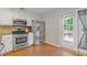Bright kitchen features stainless steel appliances and access to a deck through a glass door at 109 Riley Way, Canton, GA 30115