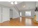 Cozy living room featuring hardwood floors, staircase, and a fireplace at 109 Riley Way, Canton, GA 30115