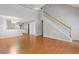 Open-concept living room with hardwood floors, staircase, and seamless flow to the kitchen at 109 Riley Way, Canton, GA 30115