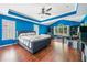 Bright bedroom features tray ceilings, a ceiling fan, modern furniture and large windows at 1162 Apalachee Run Trl, Dacula, GA 30019