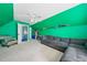 Bonus room featuring a sofa, carpet, and green accent wall at 1162 Apalachee Run Trl, Dacula, GA 30019