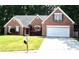 Charming brick home with well-manicured lawn, two-car garage, and inviting front entrance at 1162 Apalachee Run Trl, Dacula, GA 30019