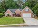 Charming one-story brick home with attached garage and well-manicured lawn at 1162 Apalachee Run Trl, Dacula, GA 30019