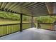Inviting covered back porch with railing overlooking a spacious, green backyard at 1253 Willow Dr, Riverdale, GA 30296