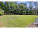 Sprawling, lush backyard with ample green space and mature trees providing privacy at 1253 Willow Dr, Riverdale, GA 30296