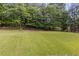 Lush green backyard offering plenty of space and seclusion from mature trees and a fence at 1253 Willow Dr, Riverdale, GA 30296