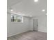 Finished basement with gray plank flooring, modern lighting and neutral paint at 1253 Willow Dr, Riverdale, GA 30296