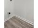 Basement featuring plank flooring, white walls and a modern utility hookup at 1253 Willow Dr, Riverdale, GA 30296