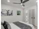 Bright bedroom with an attached bathroom and closet featuring a ceiling fan and neutral decor at 1253 Willow Dr, Riverdale, GA 30296