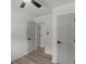 Bright bedroom featuring a ceiling fan, closet and wood-look laminate flooring at 1253 Willow Dr, Riverdale, GA 30296