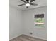 Cozy bedroom featuring a ceiling fan, window, and wood-look laminate flooring at 1253 Willow Dr, Riverdale, GA 30296