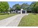 Stylish home with a long driveway, carport, and freshly landscaped front yard at 1253 Willow Dr, Riverdale, GA 30296