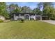 Charming two-story home with black and white accents and a well-manicured lawn at 1253 Willow Dr, Riverdale, GA 30296