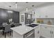Modern kitchen featuring white cabinets, quartz countertops, stainless steel appliances, and an adjacent dining area at 1253 Willow Dr, Riverdale, GA 30296