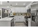 Bright kitchen featuring stainless steel appliances, quartz countertops, white cabinets, and modern fixtures at 1253 Willow Dr, Riverdale, GA 30296