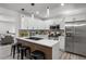Modern kitchen with stainless steel appliances, island seating, and sleek countertops at 1253 Willow Dr, Riverdale, GA 30296