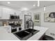 Bright kitchen featuring stainless steel appliances, quartz countertops, white cabinets, and modern fixtures at 1253 Willow Dr, Riverdale, GA 30296