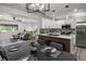 Open-concept kitchen with modern appliances, island seating, and adjacent living area at 1253 Willow Dr, Riverdale, GA 30296