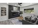 Cozy living room featuring a modern fireplace, sleek ceiling fan, and stylish decor at 1253 Willow Dr, Riverdale, GA 30296
