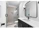 Modern bathroom with frameless glass shower, dark vanity, and contemporary fixtures at 206 Regester Way, Peachtree City, GA 30269
