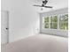 Bright bedroom featuring ceiling fan, and large windows with outdoor views at 206 Regester Way, Peachtree City, GA 30269