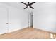 This bedroom features hardwood floors, white walls, and a ceiling fan for optimal comfort at 206 Regester Way, Peachtree City, GA 30269