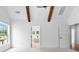 Light-filled bedroom with wood beams and an open doorway to a bright bathroom at 206 Regester Way, Peachtree City, GA 30269