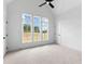 Bright bedroom featuring vaulted ceiling, ceiling fan, and large windows with outdoor views at 206 Regester Way, Peachtree City, GA 30269